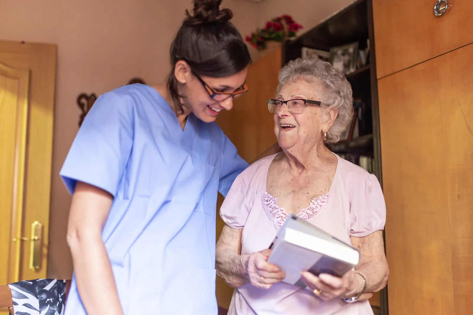 Care worker and older woman going through paperwork together