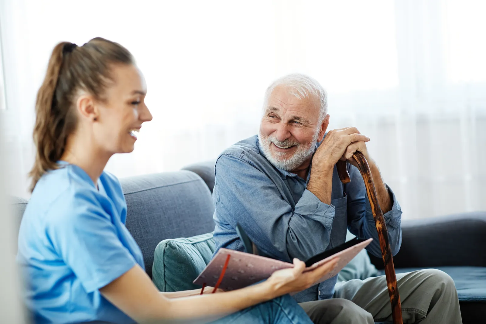 Care worker visiting an elderly man at home